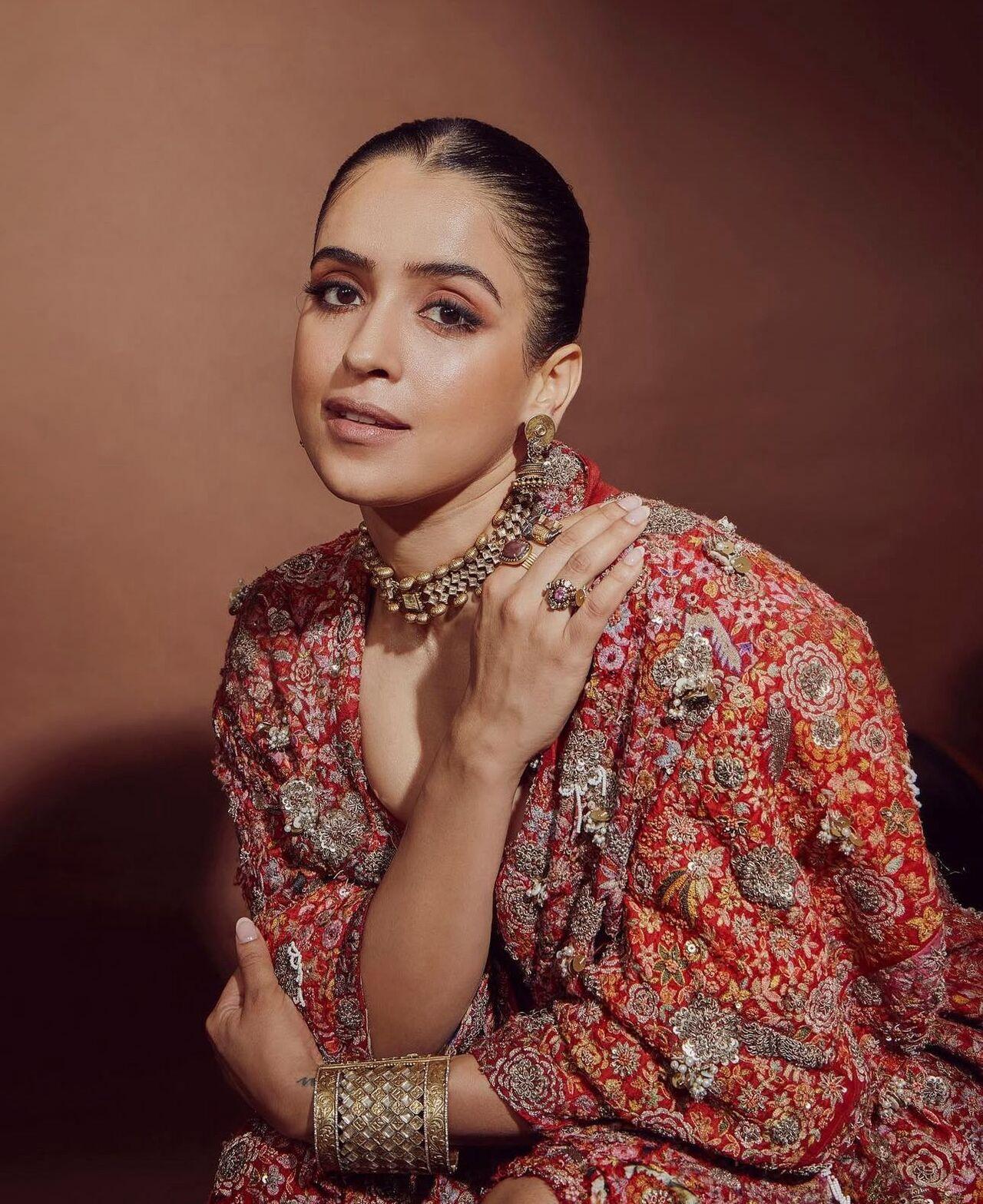 Breaking away from the expected, Sanya rocks a bold orange jacket. Layer it over traditional wear or pair it with a crop top and palazzos — this look is perfect for those who love to experiment.